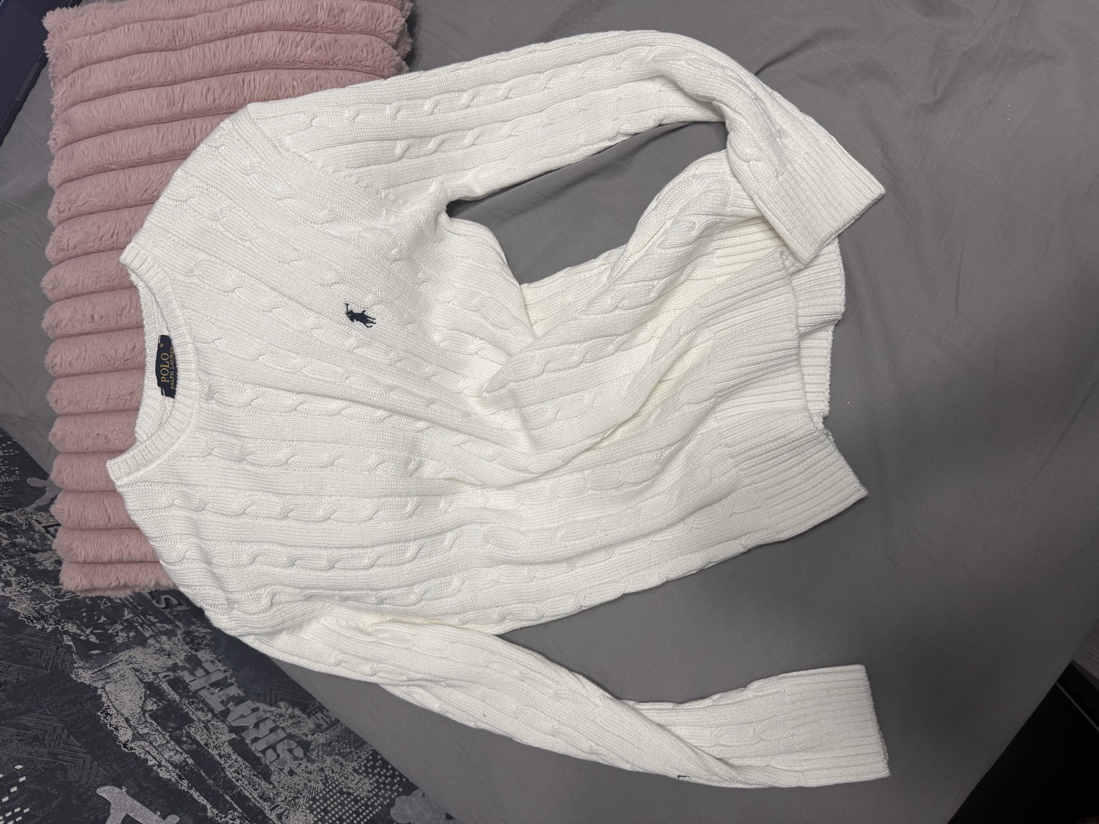 Messy bedroom photo of a sweater before enhancement
